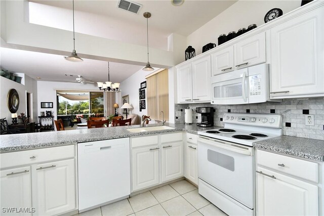 kitchen featuring light tile patterned floors, white appliances, a sink, visible vents, and tasteful backsplash