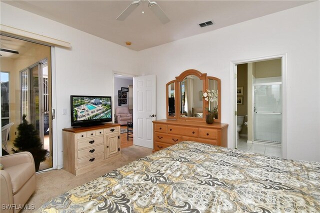 bedroom featuring light carpet, a ceiling fan, visible vents, and connected bathroom