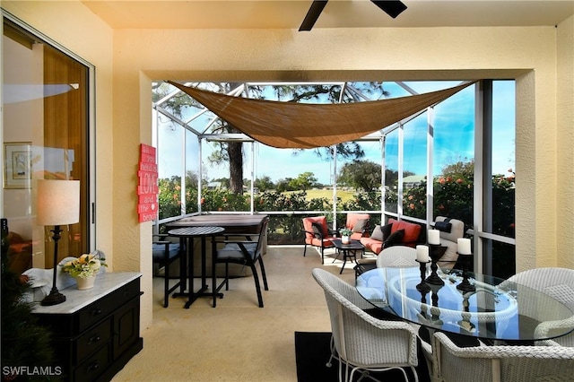 sunroom featuring a ceiling fan