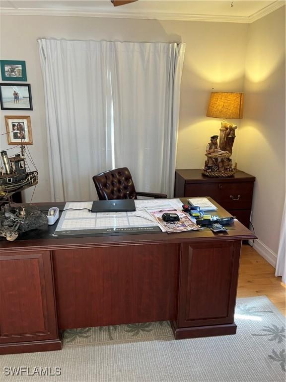 office space featuring ornamental molding and light hardwood / wood-style floors