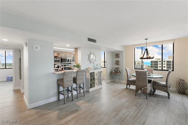 dining space featuring a notable chandelier and hardwood / wood-style floors