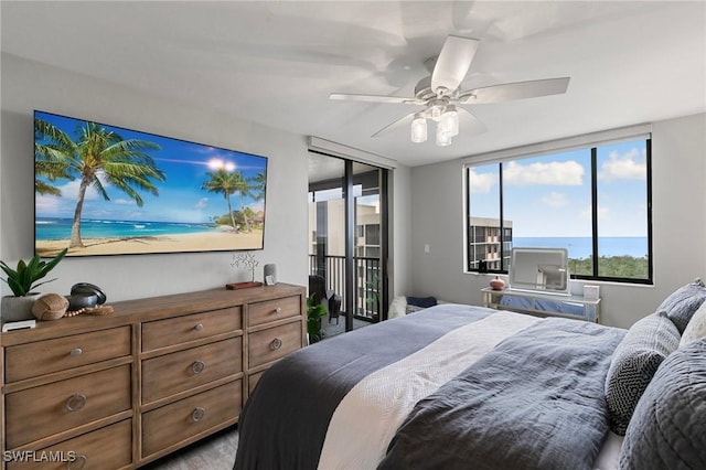 bedroom with ceiling fan, a closet, and a water view