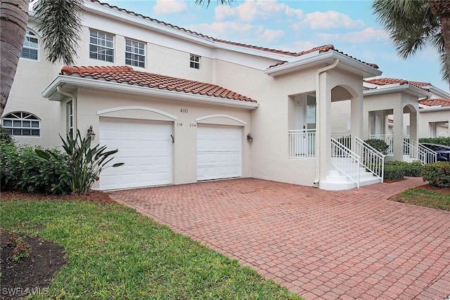 mediterranean / spanish home with a garage