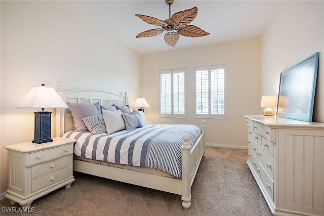 bedroom featuring light colored carpet, baseboards, and ceiling fan
