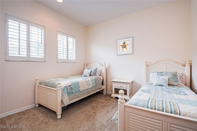 bedroom featuring light colored carpet and baseboards