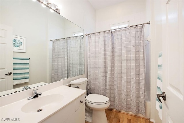 full bathroom with wood finished floors, toilet, vanity, and shower / bath combo with shower curtain