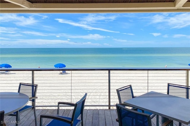 400 L Ambiance Cir Unit 204, Naples, FL 34108 - balcony featuring a water view and outdoor dining area
