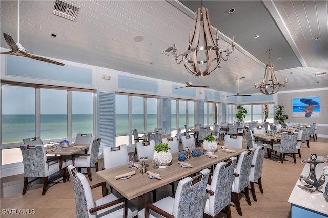 400 L Ambiance Cir Unit 204, Naples, FL 34108 - dining space featuring a chandelier, ceiling fan, a water view, and light tile patterned floors
