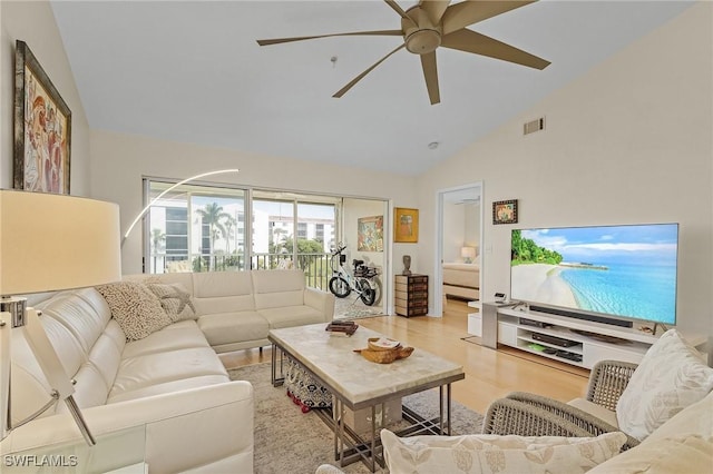 living room featuring ceiling fan, high vaulted ceiling, and light hardwood / wood-style floors