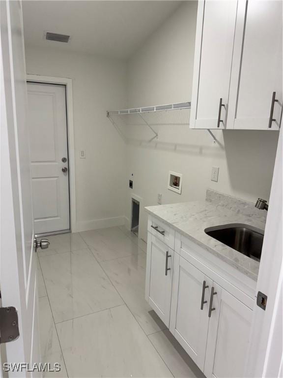 washroom with washer hookup, cabinets, hookup for an electric dryer, and sink