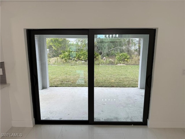 doorway to outside featuring tile patterned floors