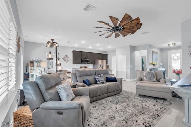 living room with ceiling fan and light tile patterned flooring