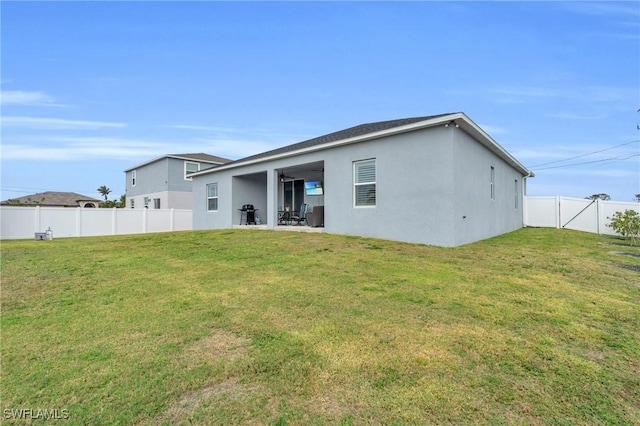 rear view of property with a lawn