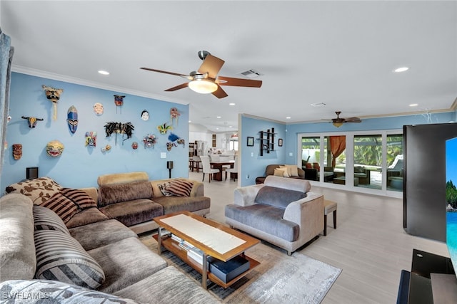 living room with ornamental molding, ceiling fan, and light wood-type flooring