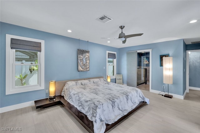 bedroom with ceiling fan, a closet, and light hardwood / wood-style flooring