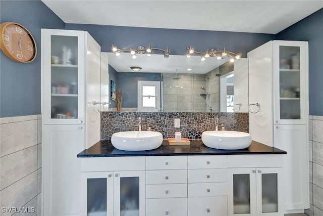 bathroom featuring vanity, tile walls, and walk in shower