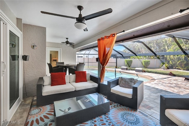 view of patio / terrace with ceiling fan, an outdoor living space, a lanai, and a fenced in pool