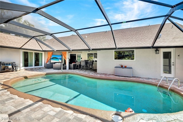 view of pool featuring a patio area and glass enclosure