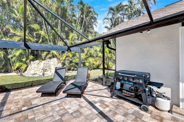 view of patio with glass enclosure