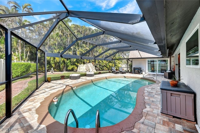 view of pool with a lanai and a patio