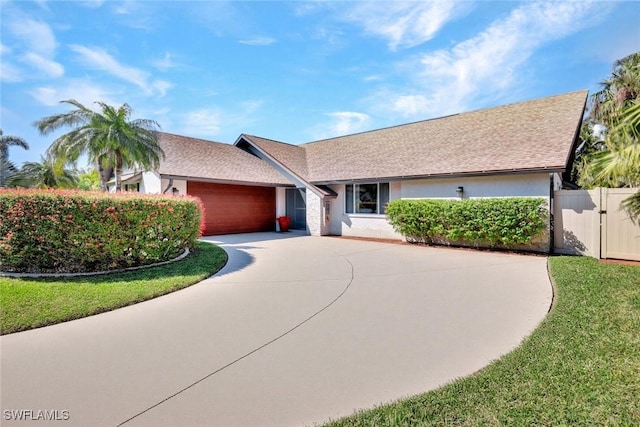 single story home with a garage and a front yard