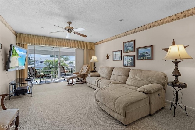 living room with ceiling fan, carpet floors, and a textured ceiling