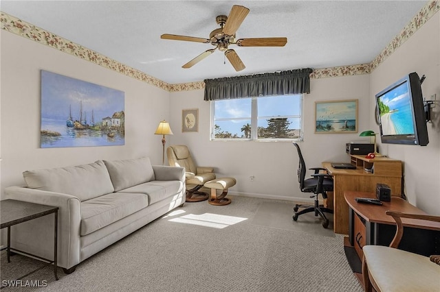 carpeted office space with ceiling fan and a textured ceiling