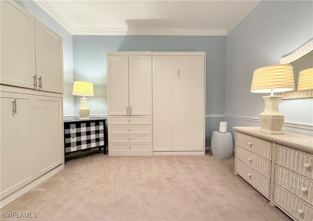 bedroom with ornamental molding and light colored carpet