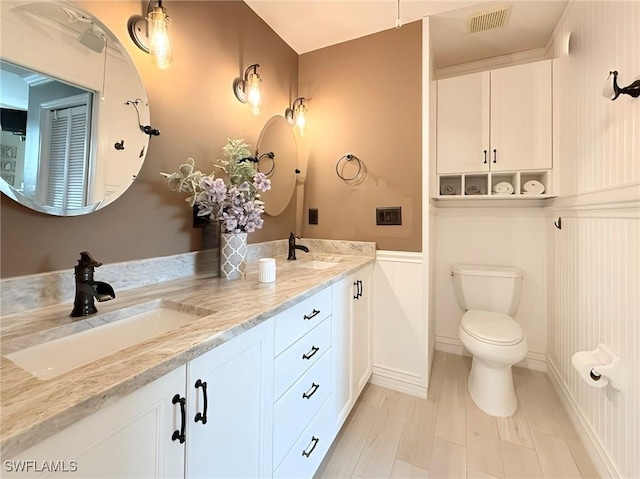 bathroom featuring toilet and vanity