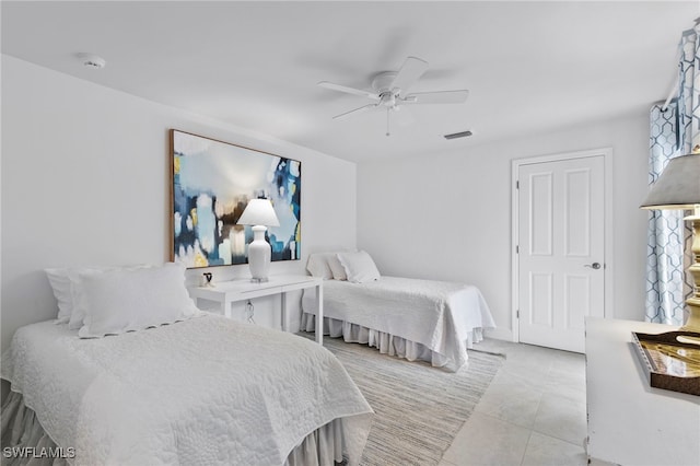 tiled bedroom with ceiling fan