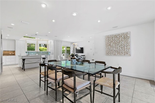 dining area with sink and light tile patterned floors