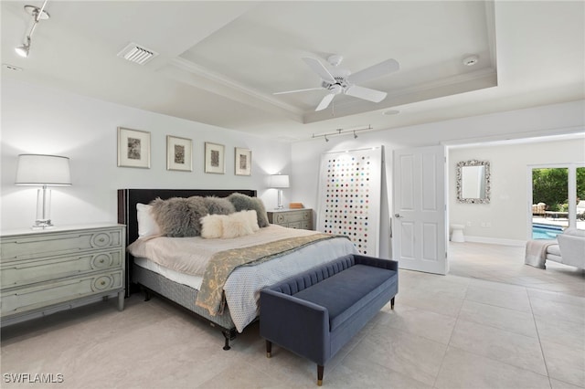 tiled bedroom with crown molding, track lighting, ceiling fan, and a tray ceiling