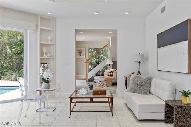 living room featuring a wealth of natural light and light tile patterned flooring