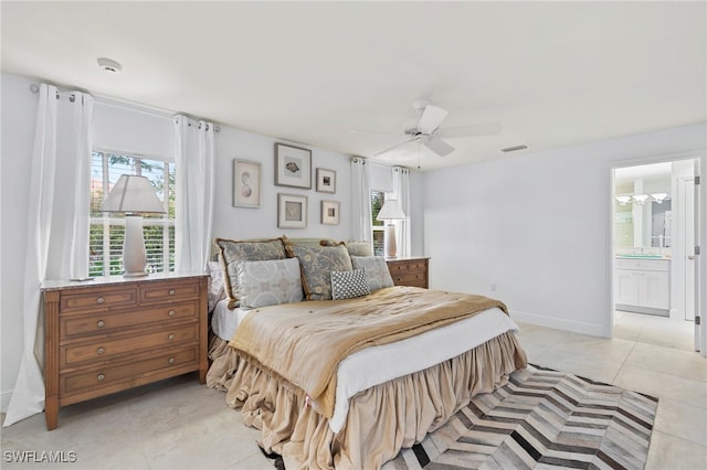 bedroom featuring light tile patterned floors, ensuite bath, and ceiling fan