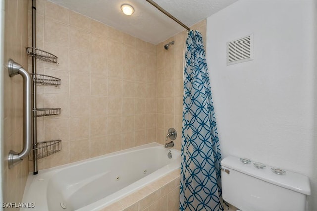 bathroom featuring toilet, a textured ceiling, and shower / bath combination with curtain