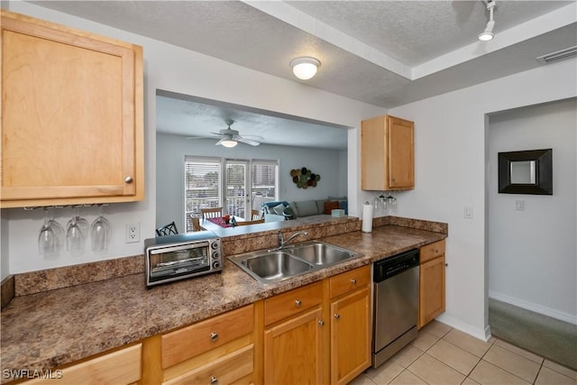 kitchen featuring ceiling fan, dishwasher, sink, a textured ceiling, and light tile patterned floors