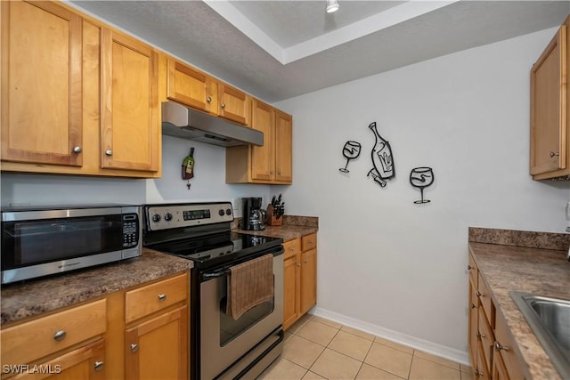 kitchen with light tile patterned floors and appliances with stainless steel finishes