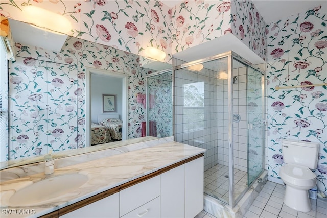 bathroom featuring vanity, toilet, a shower with shower door, and tile patterned flooring