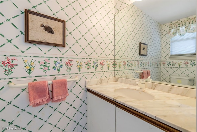 bathroom with toilet and vanity