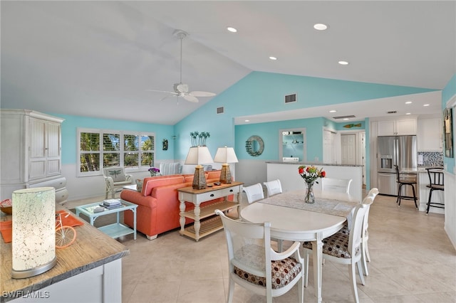 tiled dining area with vaulted ceiling and ceiling fan