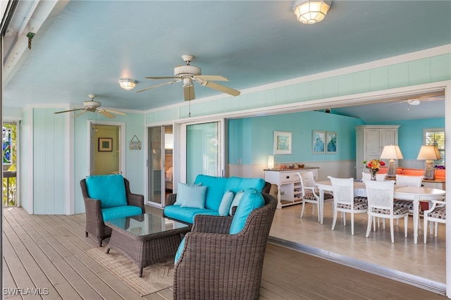 living room with ceiling fan and wood-type flooring