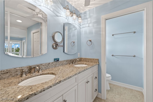 bathroom with toilet, vanity, and ceiling fan