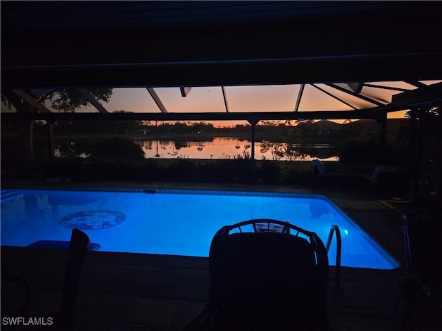 pool at dusk with a water view