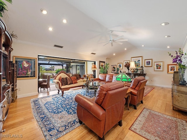 living room with light hardwood / wood-style floors, ornamental molding, ceiling fan, and vaulted ceiling