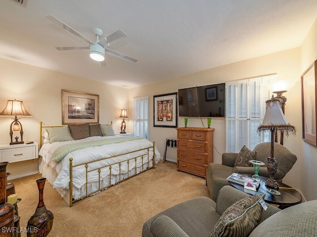 bedroom with ceiling fan and light colored carpet