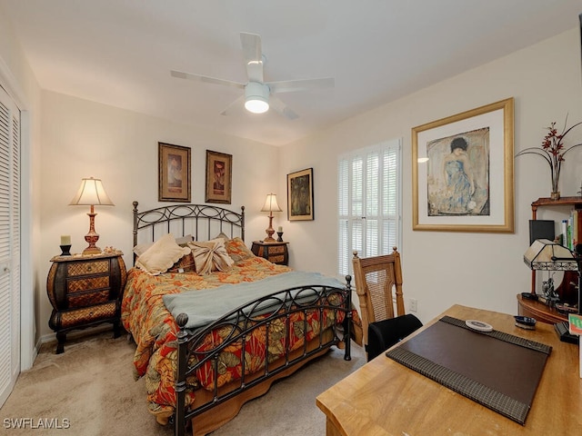 bedroom featuring a closet, ceiling fan, and light colored carpet