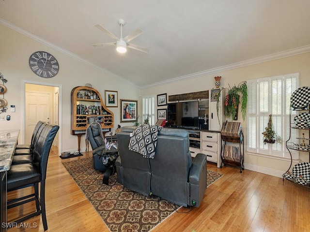 living room featuring crown molding, hardwood / wood-style floors, vaulted ceiling, and ceiling fan