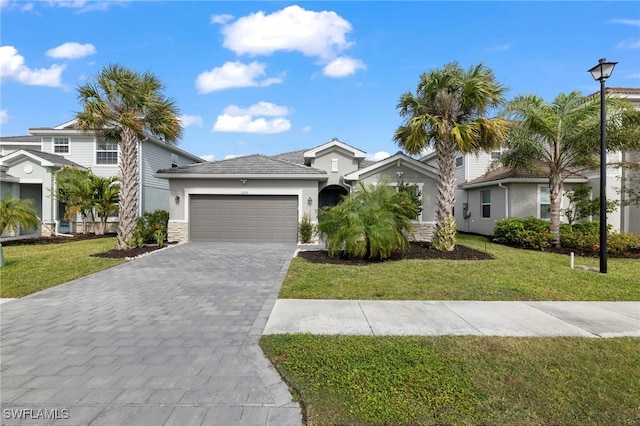 view of front of house with a front yard and a garage