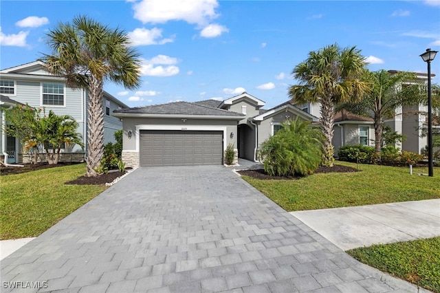 view of front of home with a garage and a front lawn