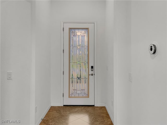 doorway with light tile patterned floors